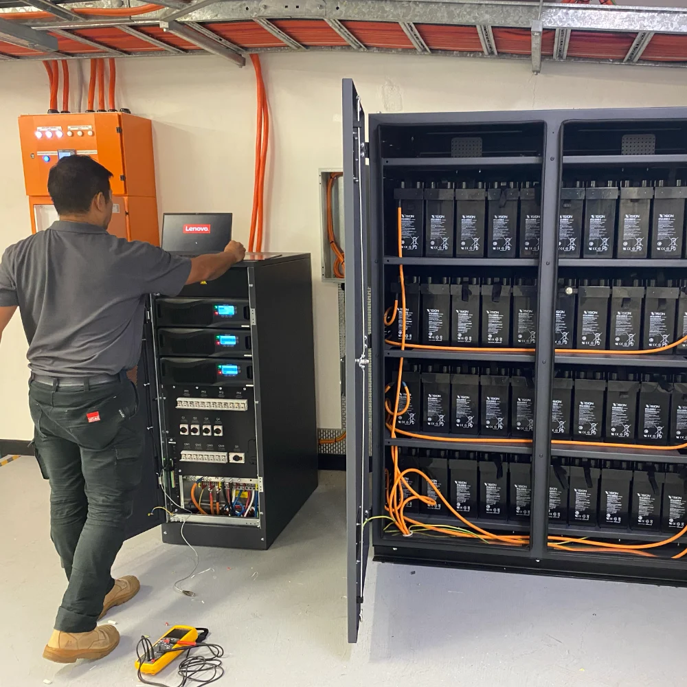 STULZ technician performing UPS maintenance.