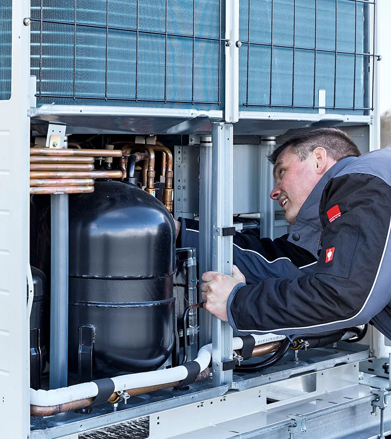 STULZ cooling maintenance technician working on outdoor unit.